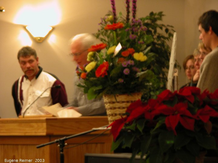 IMG 2003-Dec05 at Steinbach:  Taunte Marie funeral Harry speaking zoom