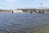 flooded field: with grain-bins and quonset shed