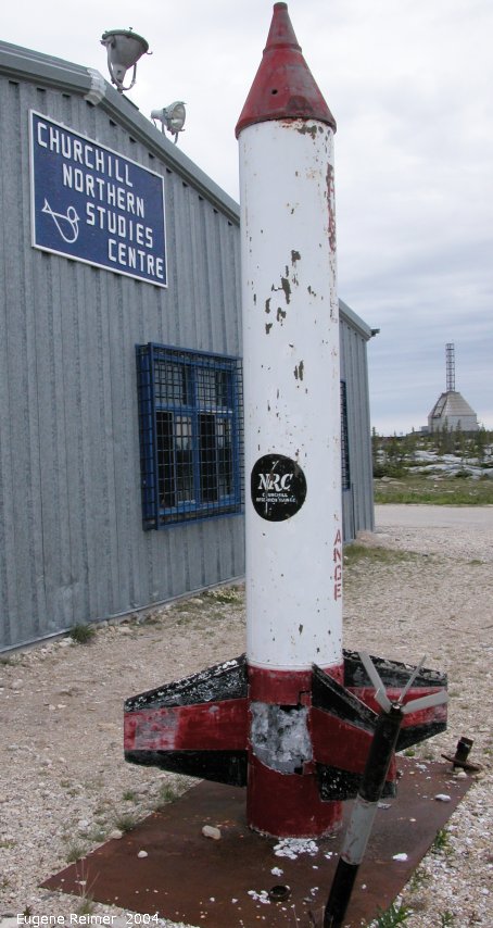 IMG 2004-Jul20 at near CNSC (afternoon):  rocket beside main bldg - inscription reads NRC Churchill Research Range