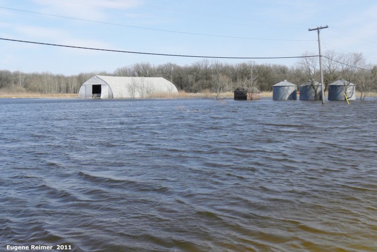 IMG 2011-Apr29 at St-Mary's Rd and SE-Winnipeg or East side of Red River:  flooded field with grain-bins and quonset shed